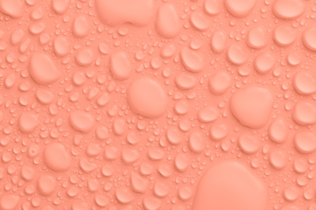 Peach colored background with water drops